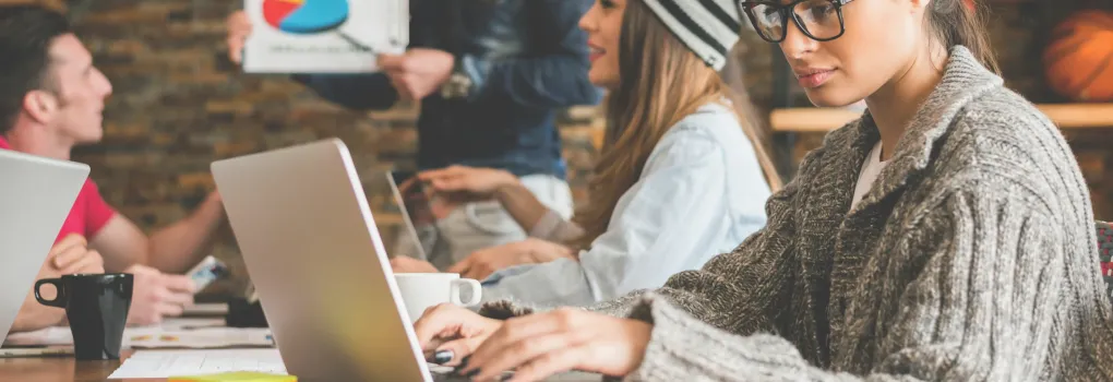 in office meeting woman on laptop