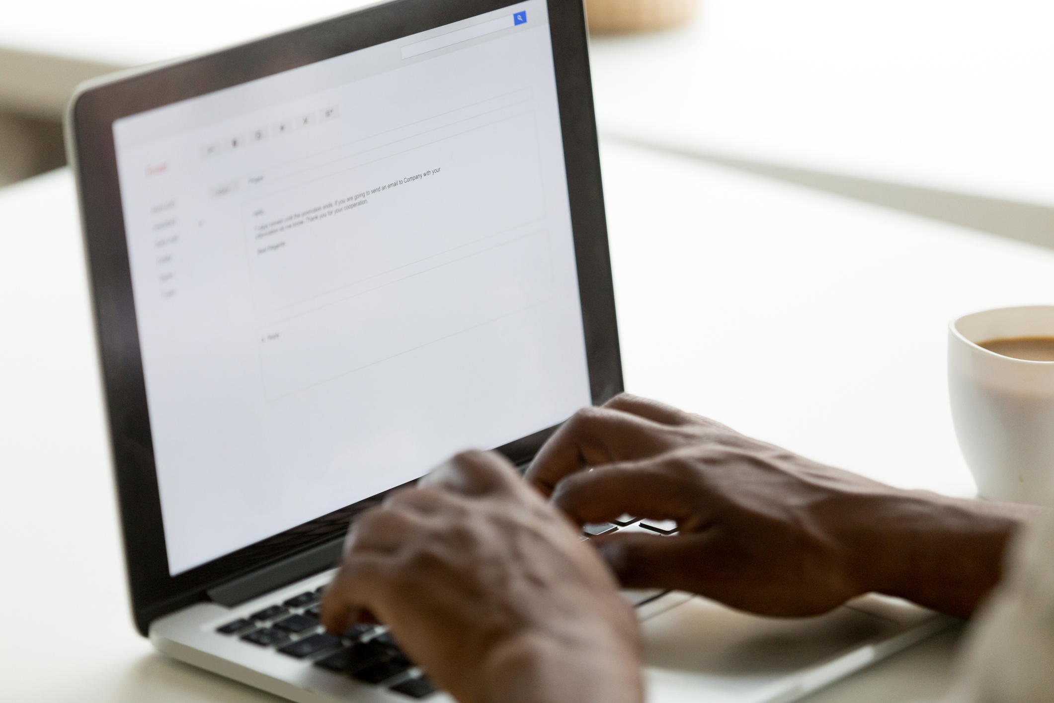 hands typing on a laptop